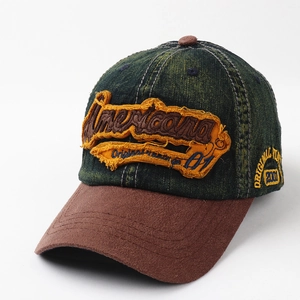 Detail of vintage baseball cap featuring distressed denim and orange Americana embroidery