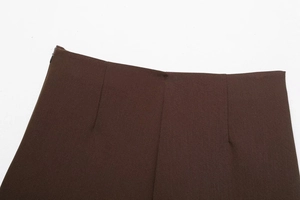 Macro view of brown asymmetrical skort waist with twill texture and invisible zipper