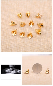 Polished gold bell pendant size comparison with coin showing petal opening design