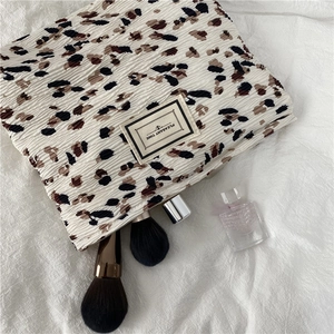 Detailed close-up of leopard print chiffon makeup bag with pleasant time label
