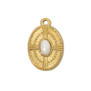 Macro detail of oval gold pendant featuring a white natural stone with a vintage finish