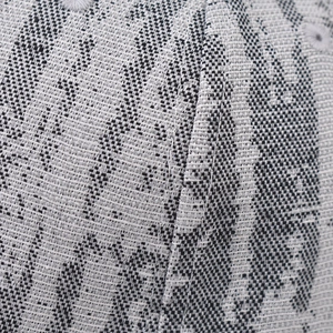 Macro shot of the thick woven plaid fabric texture on a gray and black baseball cap