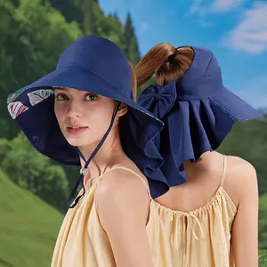 Navy sun hat with tropical leaf print brim and elegant bowknot detail for women