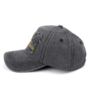 Detail of grey washed baseball cap with embroidered Forever patch and vintage distressed texture
