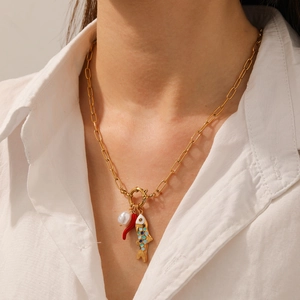 Gold chain necklace with a white pearl, red chili pepper, and colorful fish enamel pendants