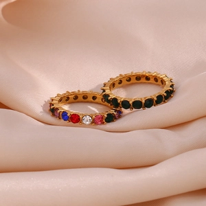 Close-up of 18K gold plated eternity rings with micro-set green and colorful cubic zirconia