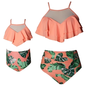 Matching mother daughter ruffled two-piece swimsuit with tropical leaf print bottoms