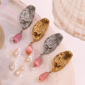 Detail of butterfly wing drop earrings with pink quartz teardrop and molten texture