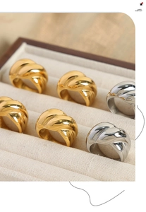 Macro view of gold and silver chunky twisted wave rings in a velvet jewelry box