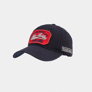 Detailed side view of navy baseball cap featuring vintage embroidery and red shield patch