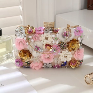 Close-up of floral evening clutch bag featuring handmade fabric flowers and sequins