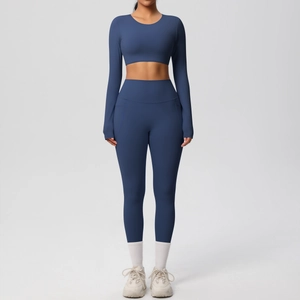 Detail of high-waist navy yoga leggings and long-sleeve crop top set in soft fabric