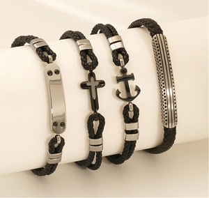Détail de bracelets en cuir tressé avec breloques en métal en forme de croix et d'ancre