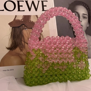 Close-up of handmade beaded handbag with pink and green translucent acrylic beads