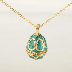 Close-up of a 18K gold-plated green enamel egg pendant necklace with zircon inlays