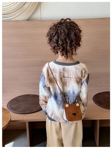 Rear view of child wearing cute brown bear crossbody bag with adjustable drawstring