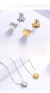 Detail of 18K gold plated snowflake necklace and earring set in fine steel