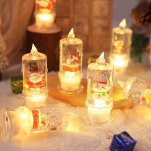 LED lighted Christmas water candle with Santa and snowman figures in warm festive scene