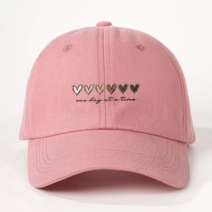 Detailed embroidery of colorful hearts and one day at a time text on pink cotton baseball cap