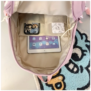 Internal view of pink nylon school backpack showing spacious compartments and storage