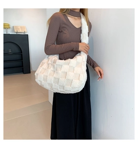 Macro view of white checkered plush shoulder bag showing soft faux fur texture