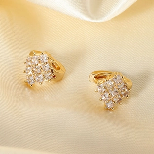 Elegant gold square zircon hoop earrings on champagne silk fabric background