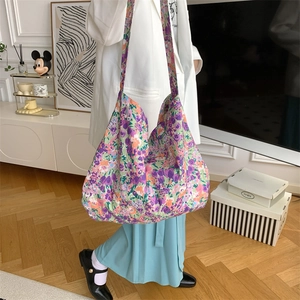 Detail of colorful floral canvas shoulder bag showing large capacity and soft texture