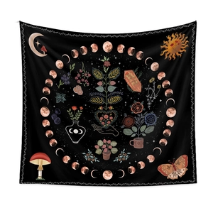 Detail of moon phases and life tree patterns on black bohemian floral tapestry