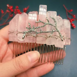 Macro view of handmade pink crystal hair comb with silver wire wrapping and branch detail