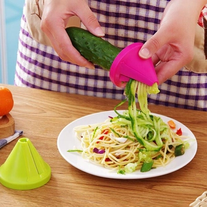 Multifunctional rotary kitchen grater for vegetables showing pink and green spiral slicers
