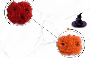 Detail of red and orange Halloween spider web decorations with small plastic spiders