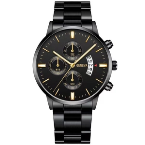 Detail of black quartz watch face with gold hands, chronograph dials and date window