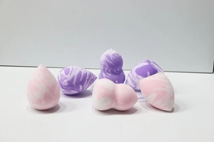 Detail of marble pattern makeup sponges in pink and purple colors for smooth blending