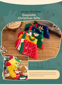 Close-up of festive cotton socks featuring Santa Claus and reindeer on a wooden table