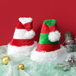 Thick plush Christmas hats with red green and white stripes on a festive background