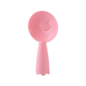 Pink standing non-stick rice paddle with cute smiley face and textured surface