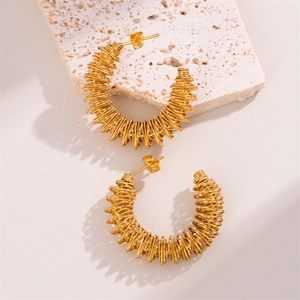 Minimalist gold coiled spring earrings with twisted geometric design on stone