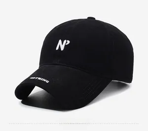 Detailed view of white embroidery on a black washed cotton baseball cap with side text
