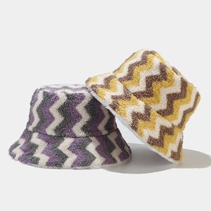 Two reversible plush bucket hats with wavy bohemian stripes for outdoor winter warmth