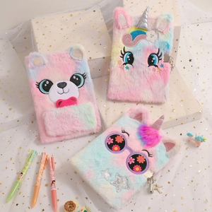 Close-up of fluffy A5 plush notebooks with cute unicorn and bear designs and metal locks