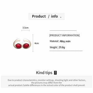 Detail view of gold resin oval earrings with 3.5cm width and 4.0cm height specifications