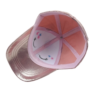 Detailed interior of a pink glitter baseball cap featuring eyelash and star embroidery