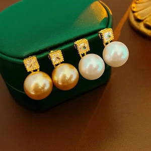 Elegant gold plated pearl earrings with square cubic zirconia in white and gold colors