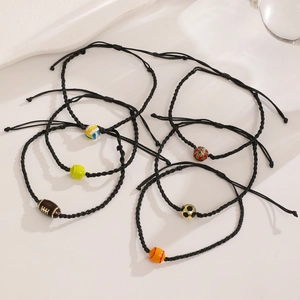 Detail showing adjustable black woven rope bracelets with assorted sports ball beads