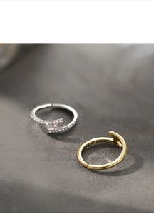 Macro detail of H-shaped adjustable rings in gold and silver with micro-pave zircons