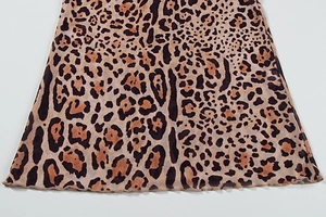 Detail of leopard print fabric featuring a delicate ruffled hem and fine texture weave
