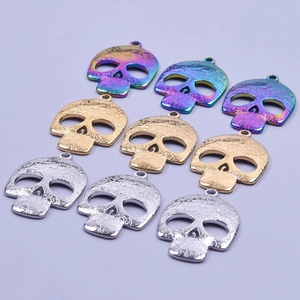 Detailed view of skull-shaped jewelry pendants with intricate floral engravings