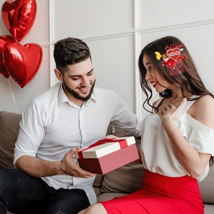 Valentine's Day red heart hair clip with XOXO design shown in a romantic gift setting