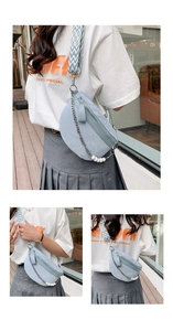 Detail of light blue crescent crossbody bag with pearl chain and geometric strap
