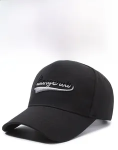 Detail showing white cursive embroidery on high-quality black cotton twill baseball cap
